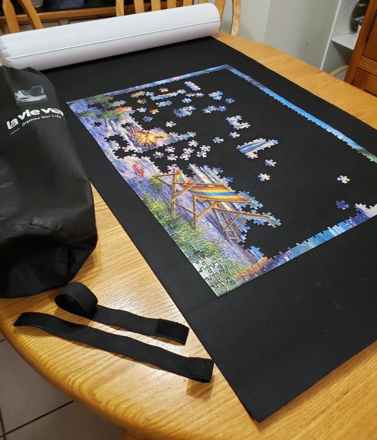 the jigsaw puzzle roll mat with a half completed puzzle on it
