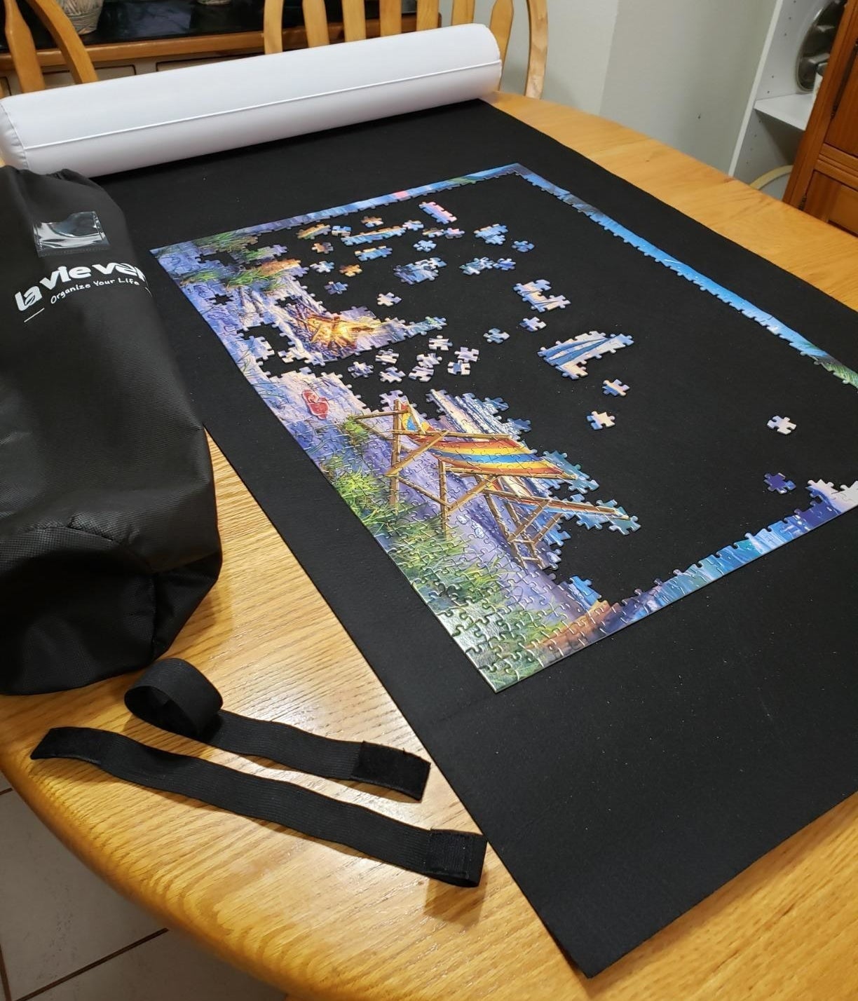 the jigsaw puzzle roll mat with a half completed puzzle on it