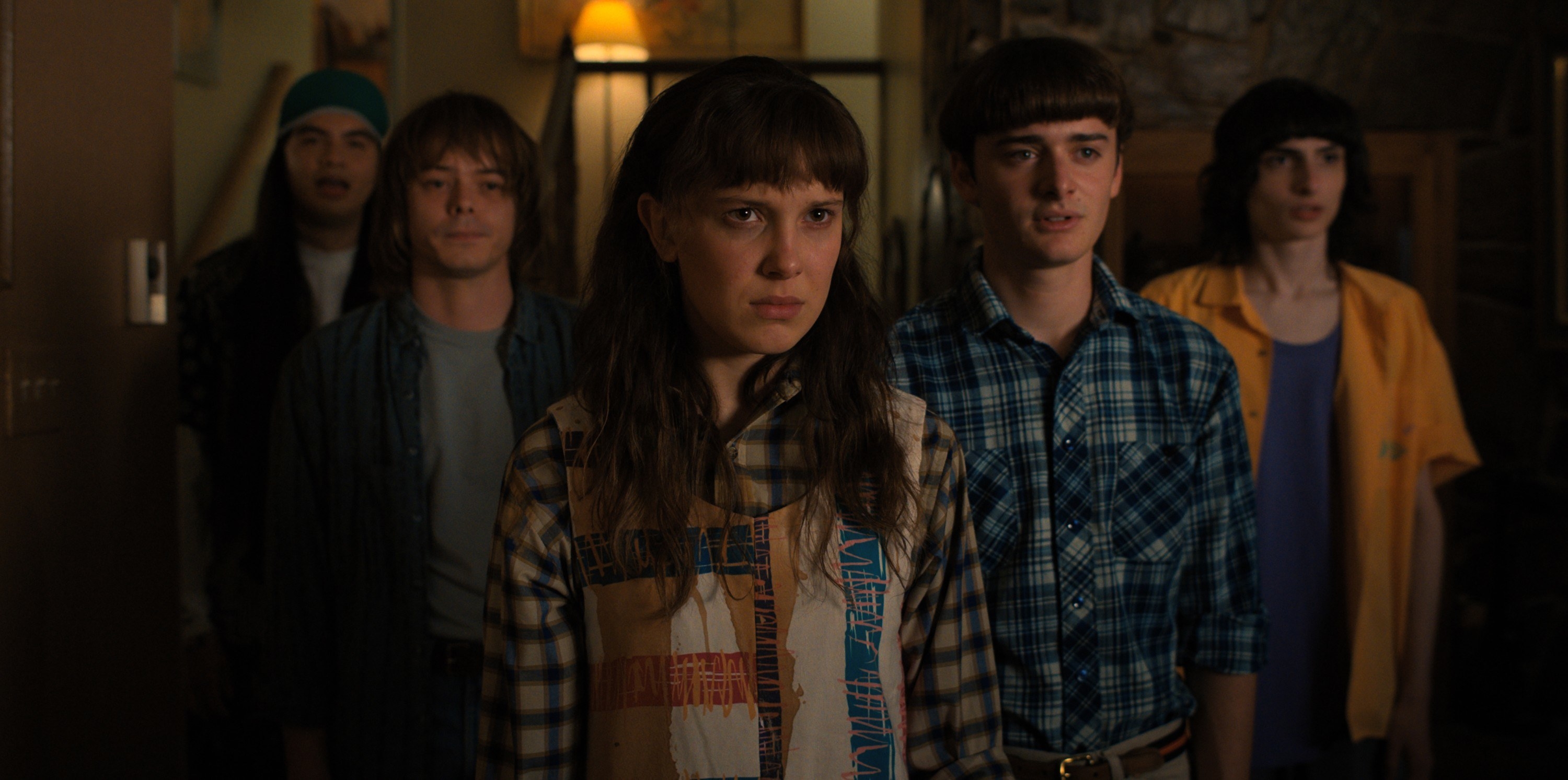 Argyle, Jonathon Byers, Will Byers, and Mike Wheeler stand in a group behind Eleven