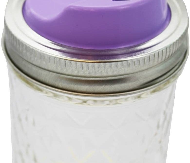 a mason jar with a purple lid adaptor installed