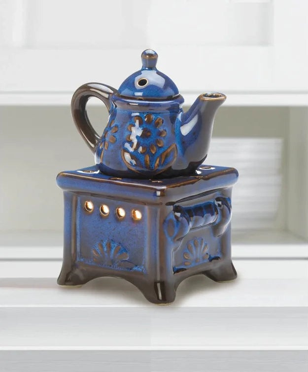 Blue, porcelain scented oil warmer on white shelf