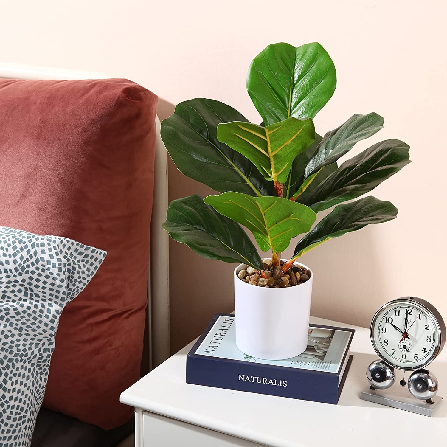 a faux fiddle leaf fig perched on a nightstand