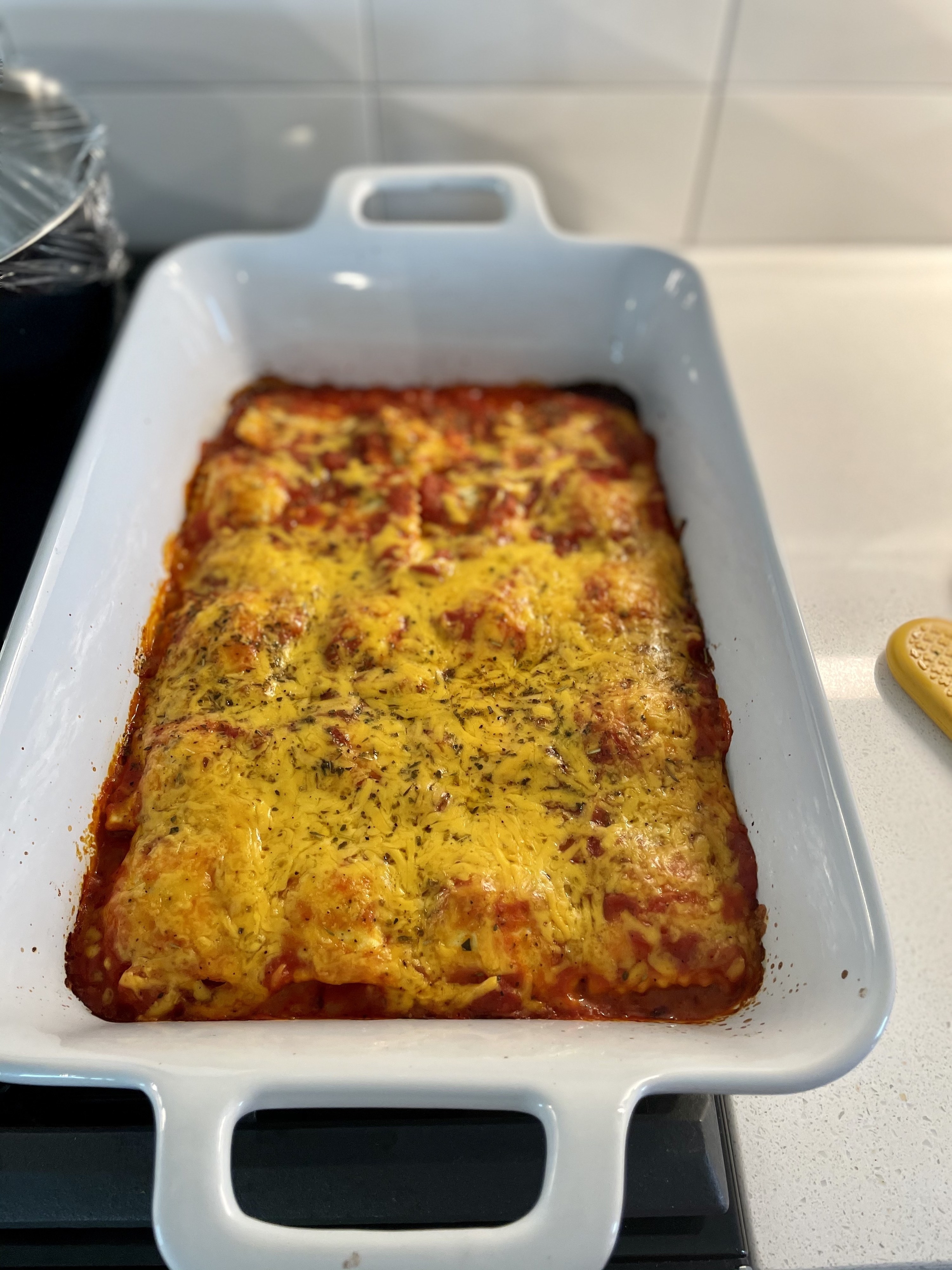 Homemade cheesy lasagna in a baking dish.