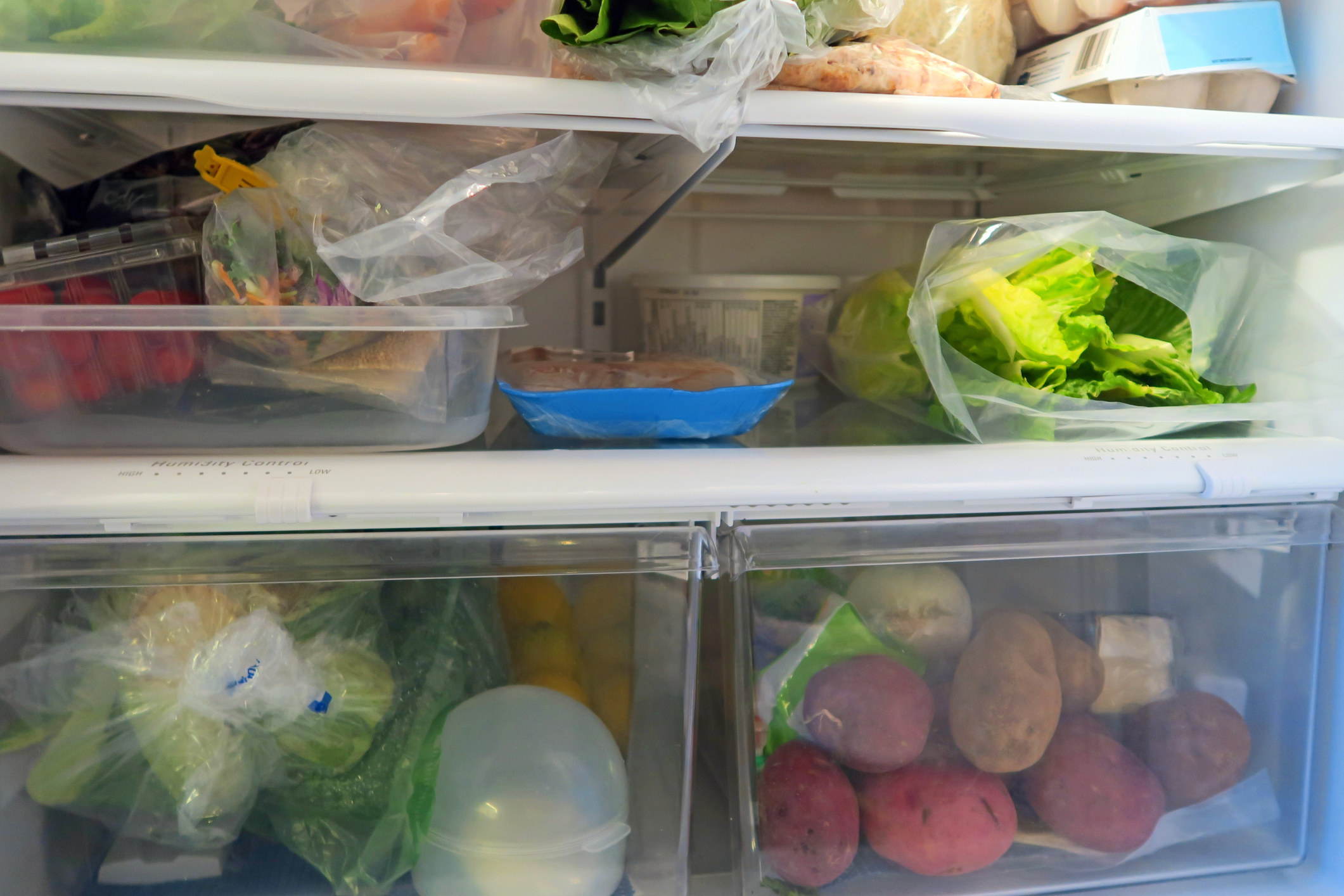 A home fridge with lots of vegetables.