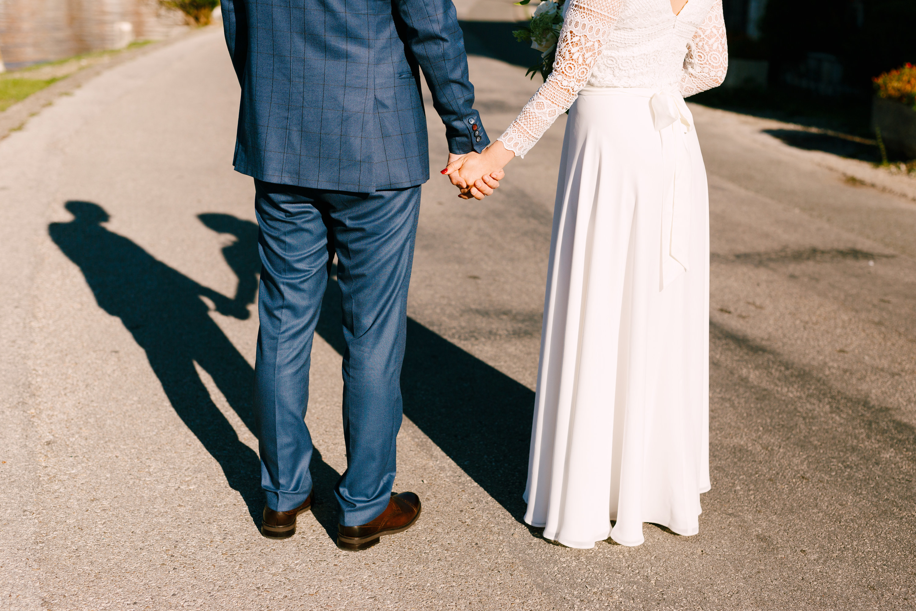 Bride and groom hand in hand