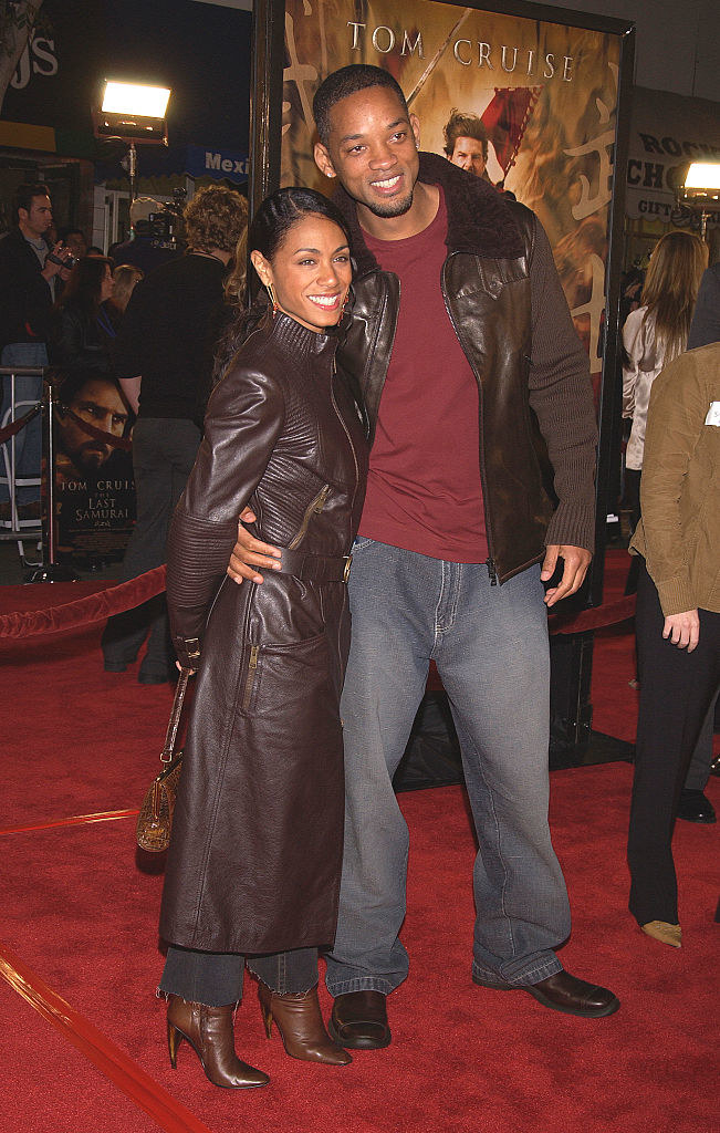 Will and Jada smiling and embracing on the red carpet