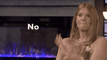 A woman waving her hands and saying, &quot;no&quot;