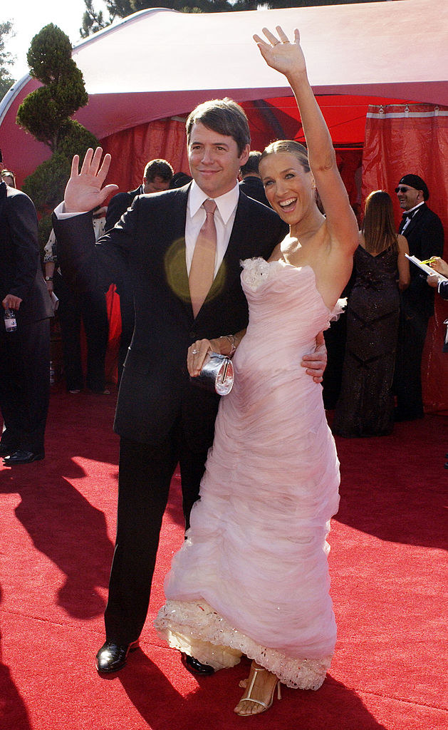 Matthew and Jessica smiling and waving on the red carpet