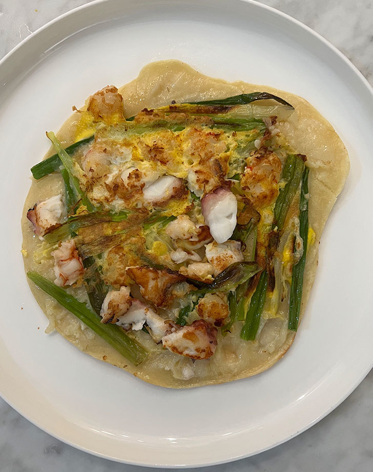 A scallion pancake with seafood.