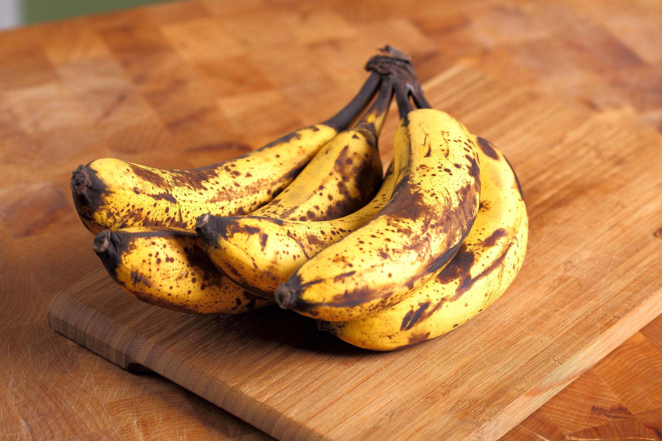 Overripe bananas on a cutting board.