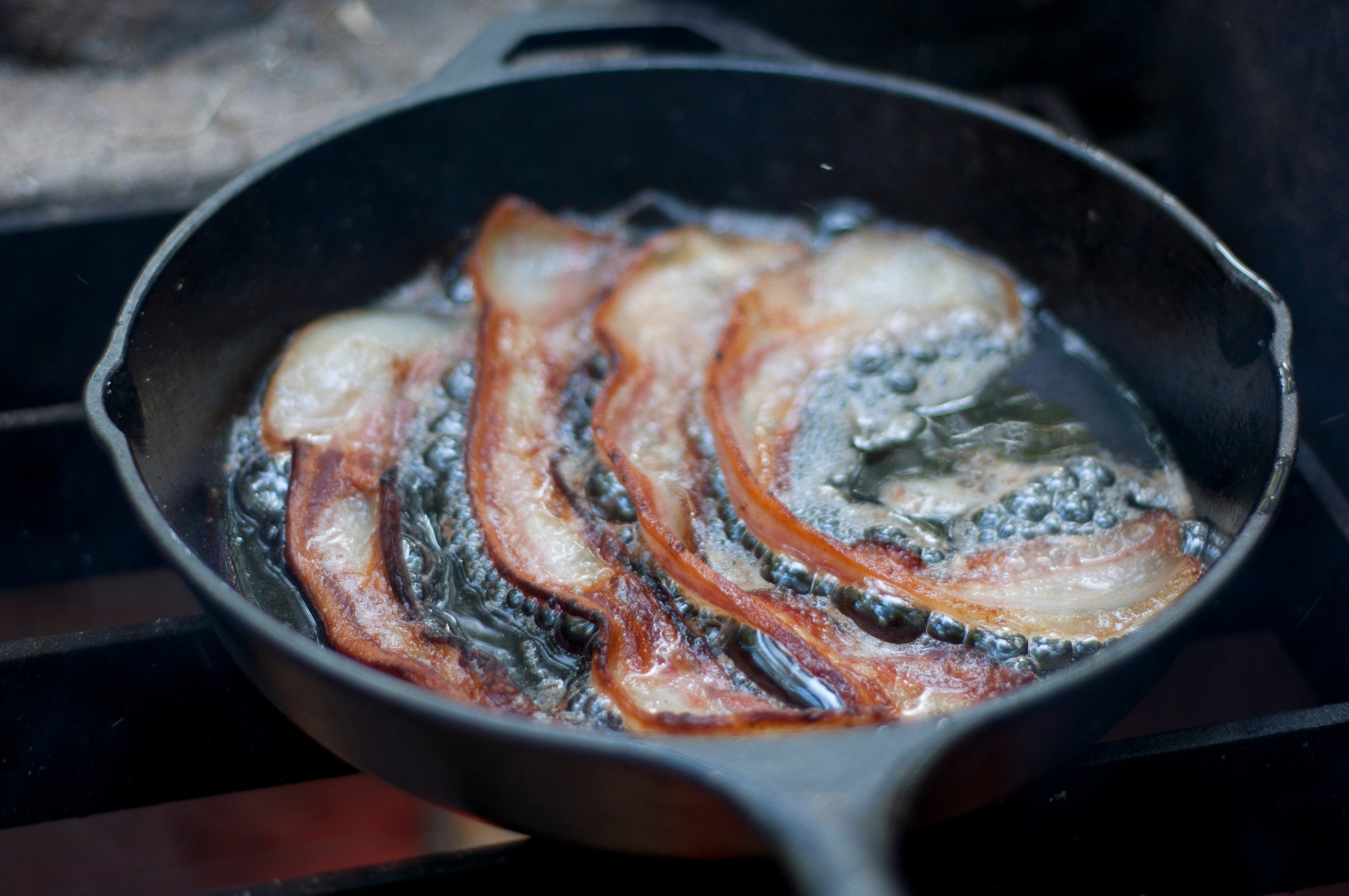 Bacon frying in a pan.