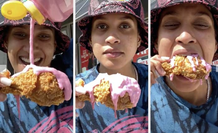 a woman pours pink sauce over fried chicken