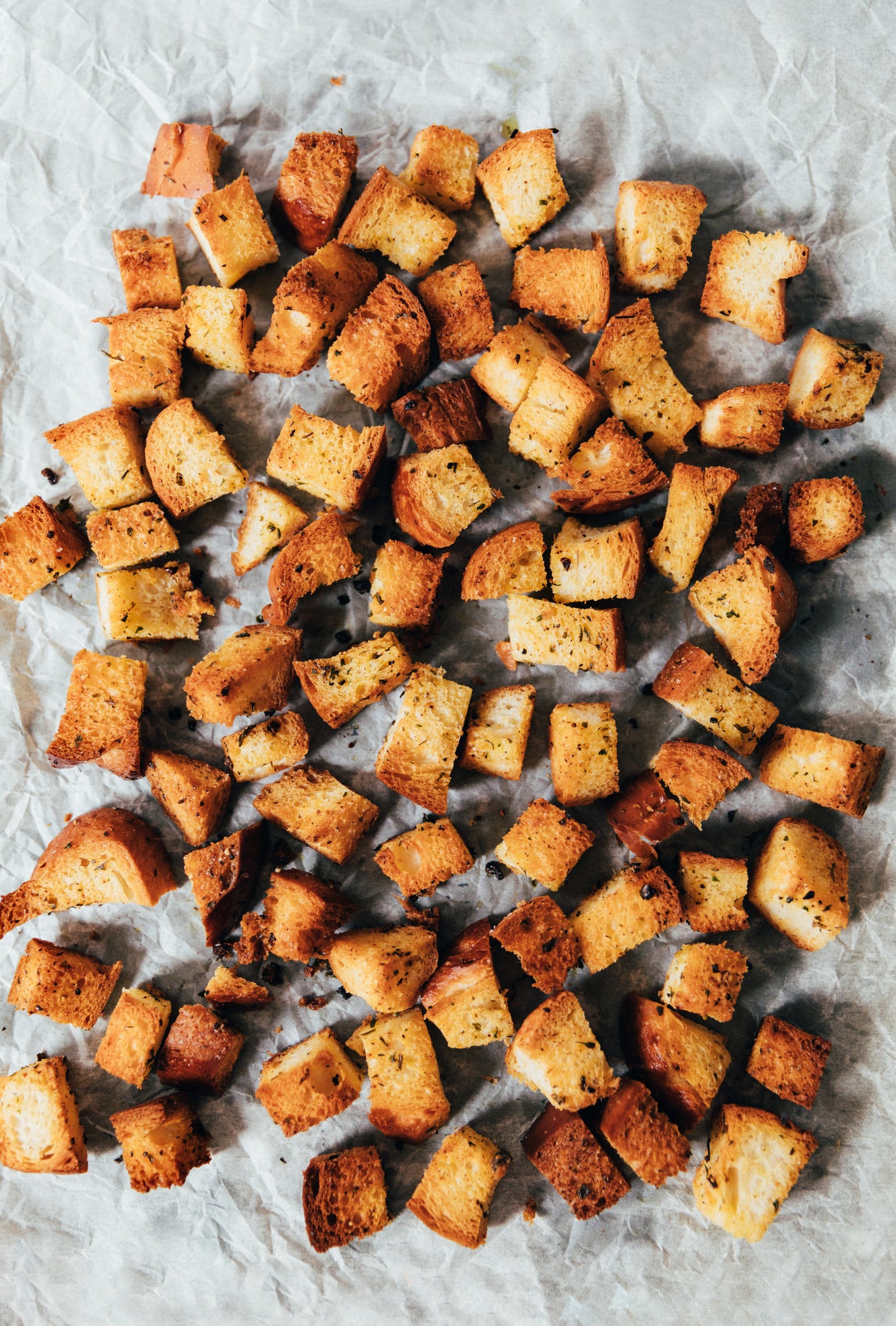 Homemade croutons on a baking sheet.