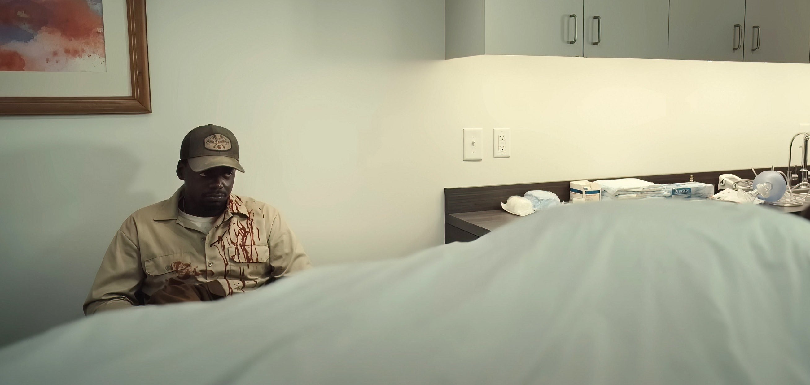 OJ in a hospital room covered in blood