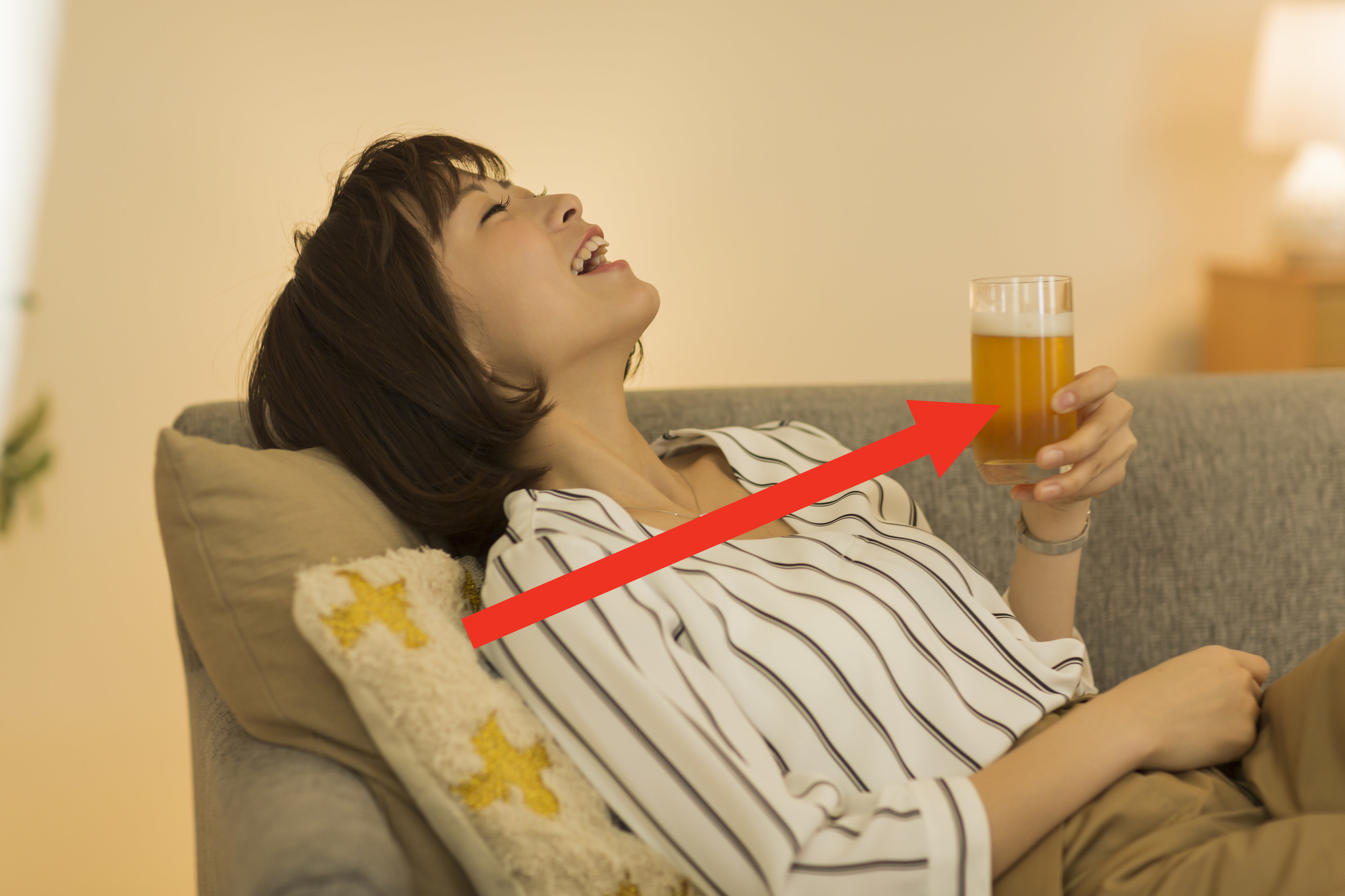 a woman laughing and holding a beer