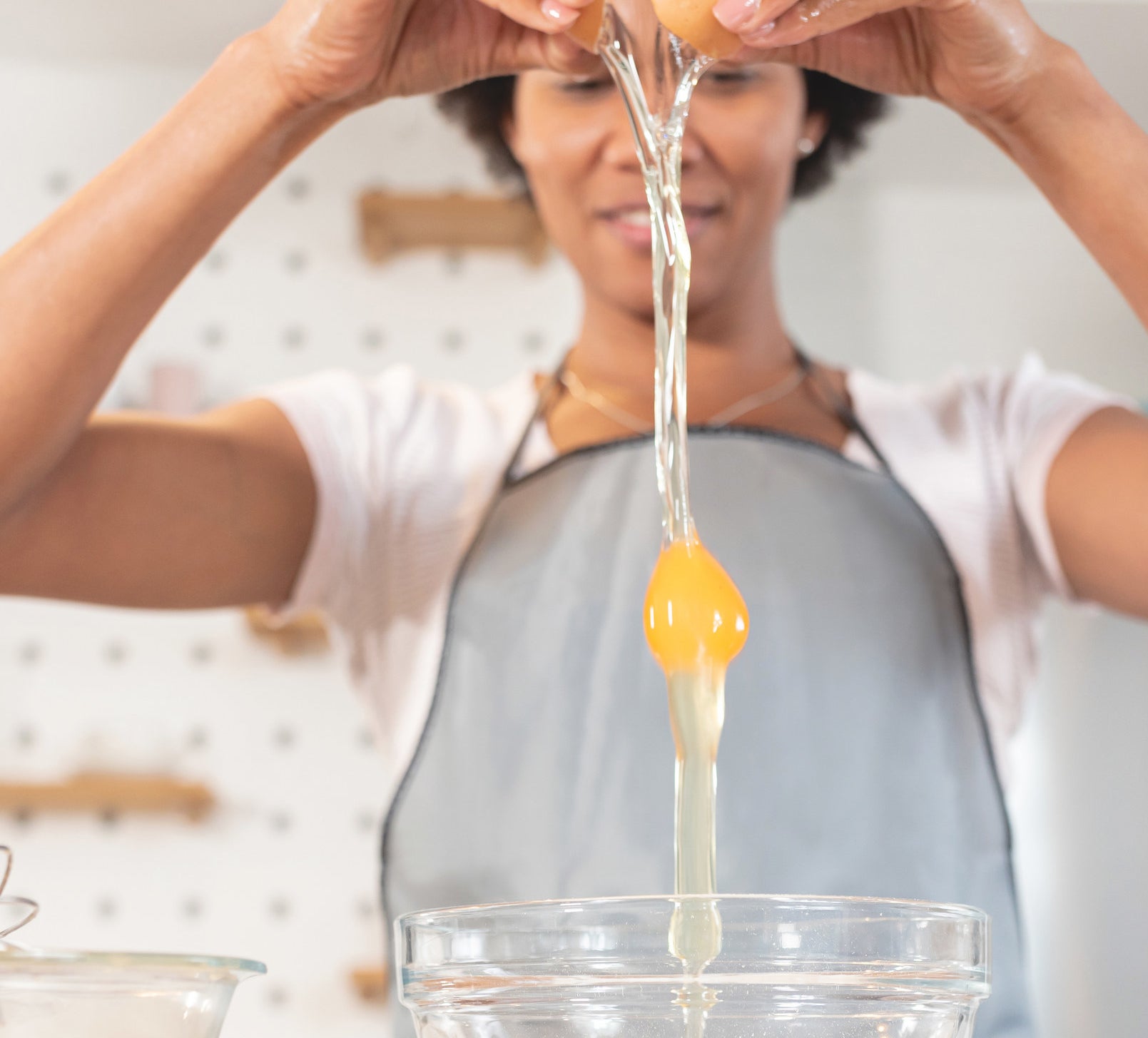 a woman cracking an egg