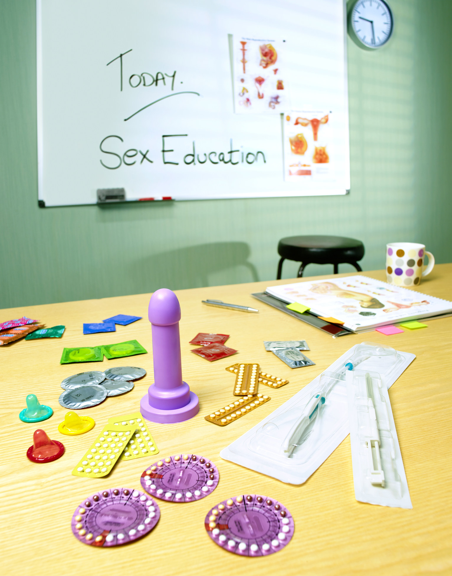 Birth control methods, including pills and condoms, on a table