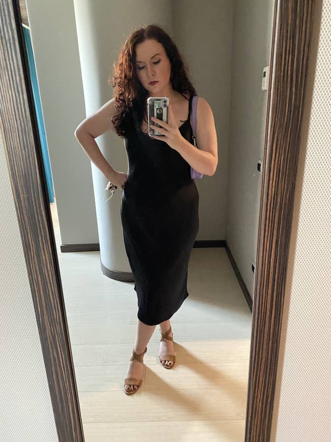 Writer in a black spaghetti-strap slip dress