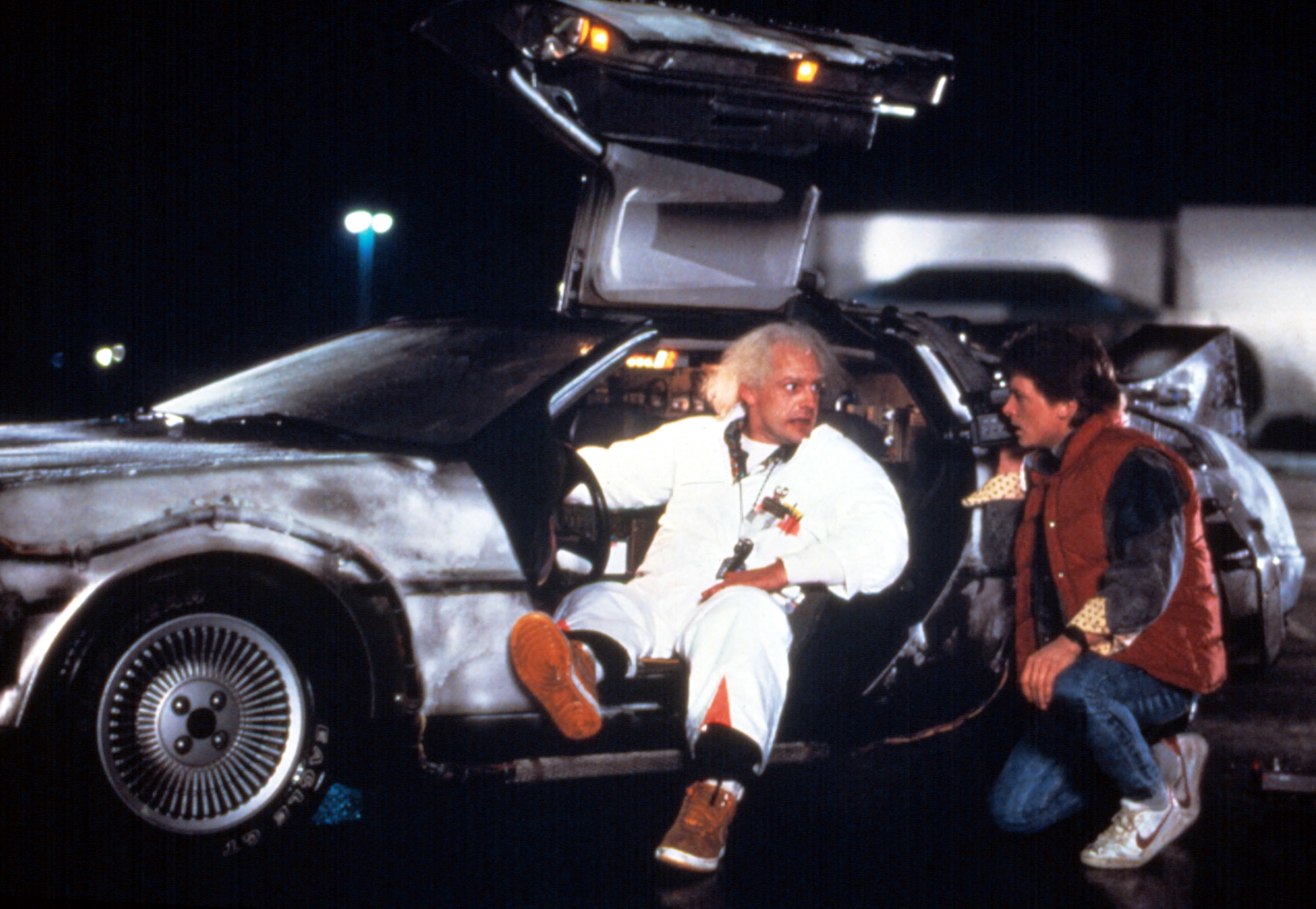 Doc and Marty McFly talking by a car