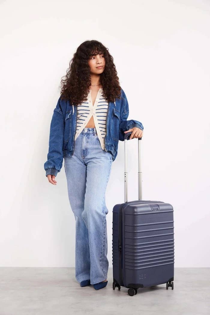 model with the roller carry on suitcase