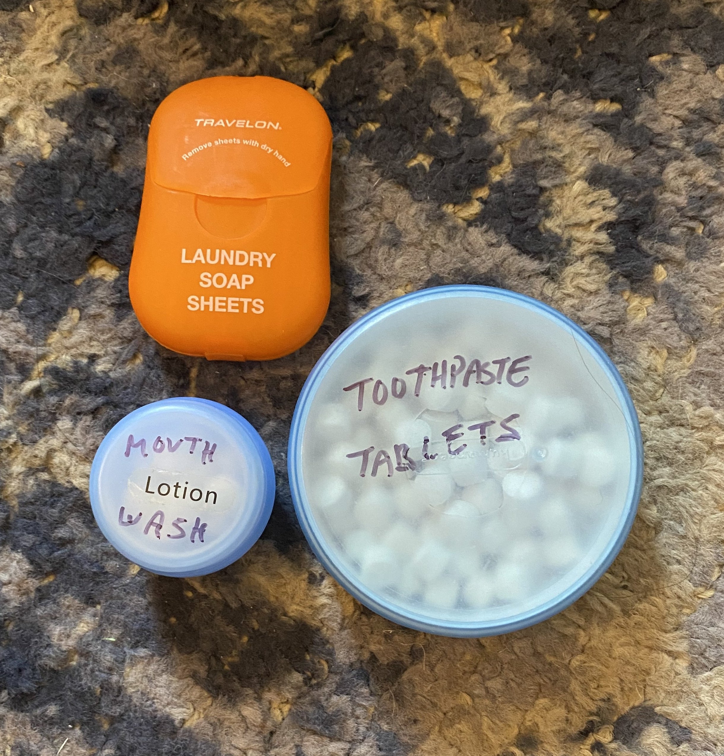 packet of laundry sheets, containers of mouthwash and toothpaste tablets
