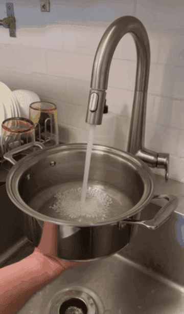 filling a stainless steel pot of water