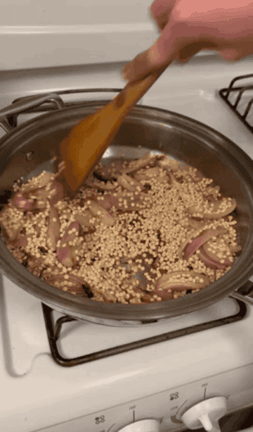 couscous and shallots in a pan