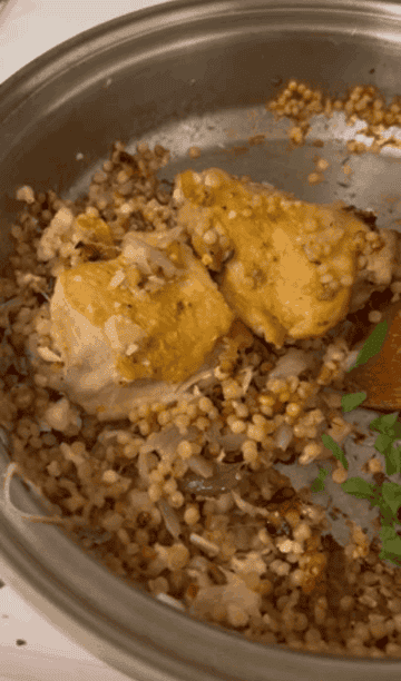 the couscous shallot dish with herbs being sprinkled over top