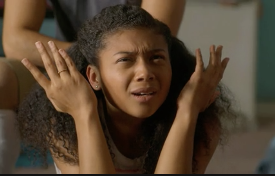 a character with her arms up and face scrunched in confusion