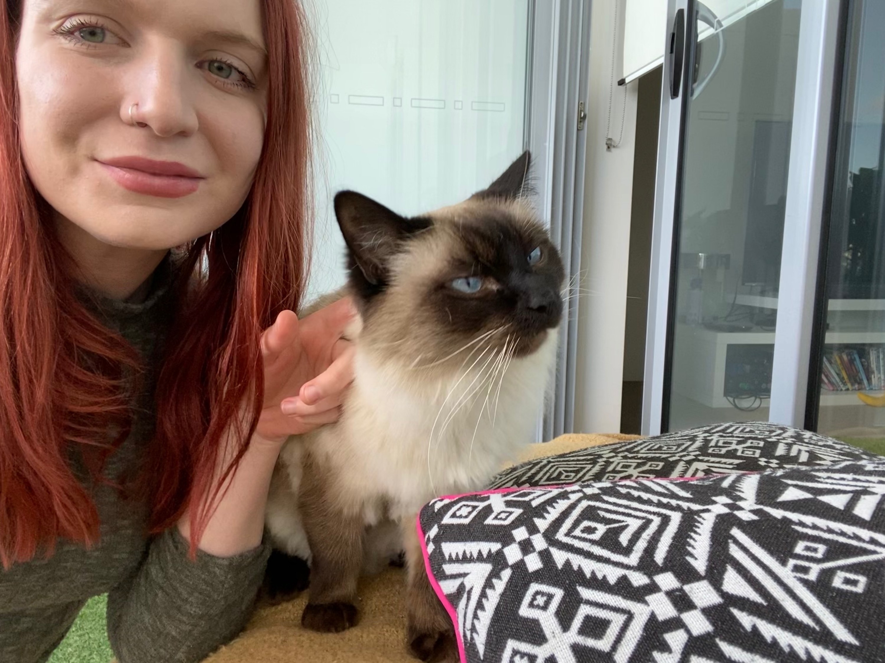 Woman and a cat taking a selfie