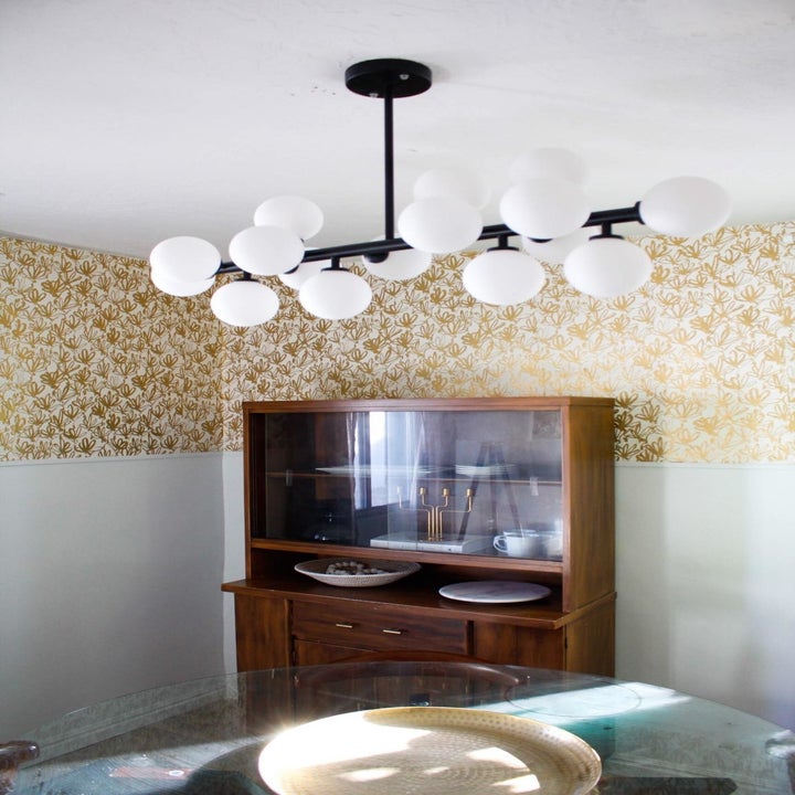 reviewer's chandelier spray painted black, hanging above a table