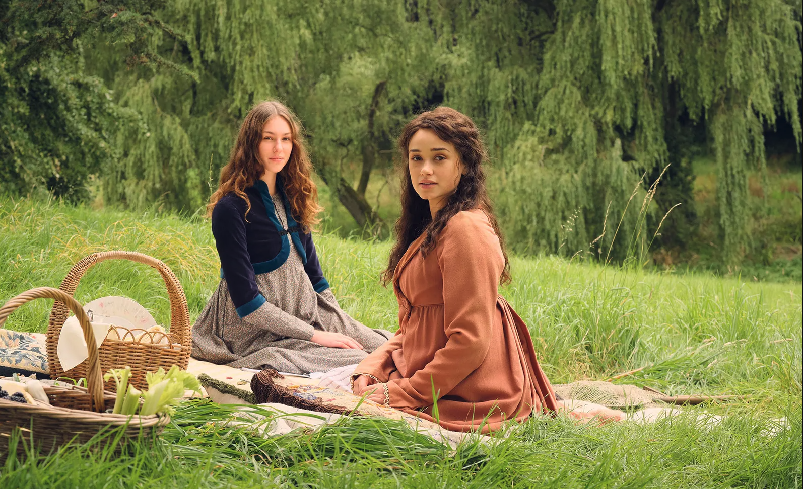 Rose williams as charlotte heywood and Eloise Webb as augusta Markham sit and have a picnic on some grass