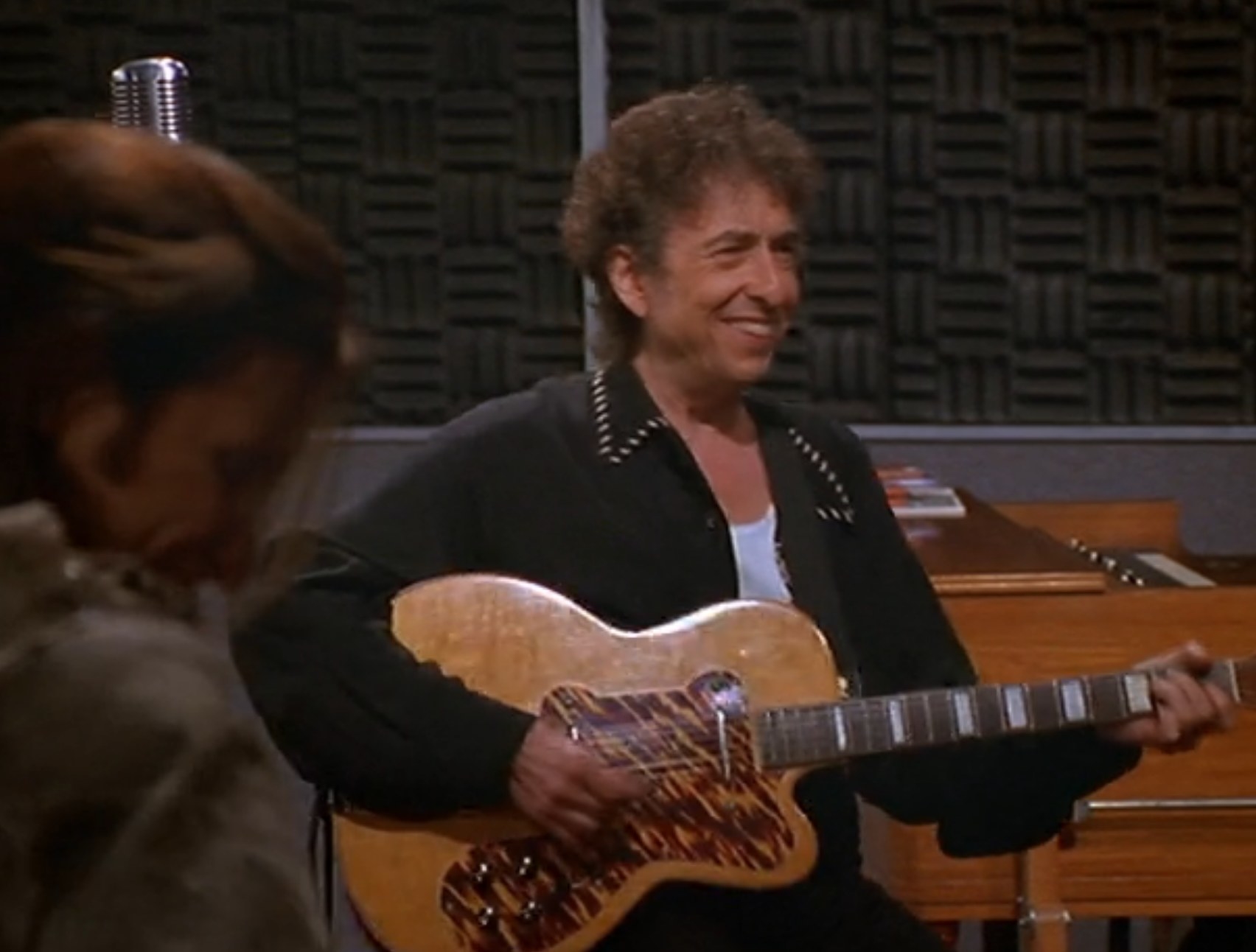 Bob Dylan smiles while holding a guitar in &quot;Dharma &amp;amp; Greg&quot;