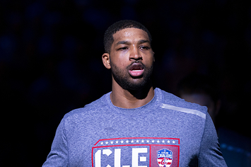 Tristan Thompson wears a blue shirt with red and white designs.