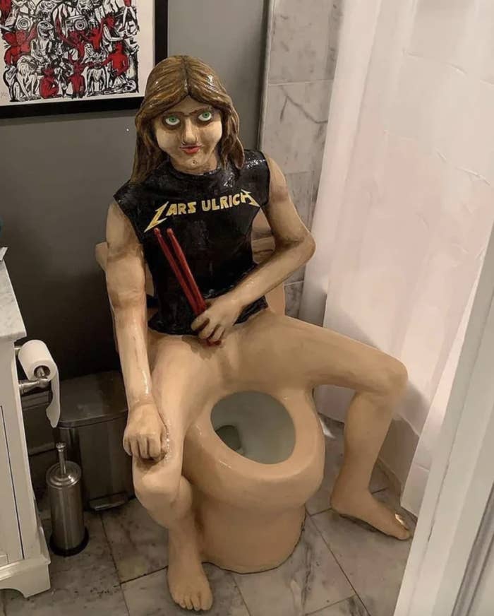 a toilet with Lars Ulrich sculpted into it