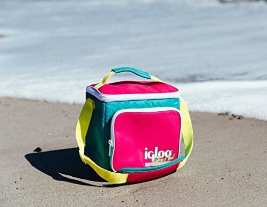 Colorful lunch box sitting on the sand