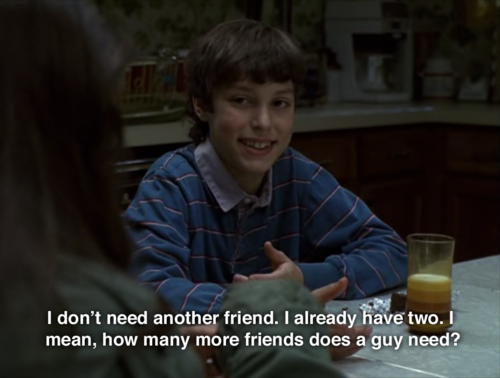 Sam sitting at a kitchen table and smiling with the caption, &quot;I don&#x27;t need another friend, I already have two. I mean, how many more friends does a guy need?&quot;