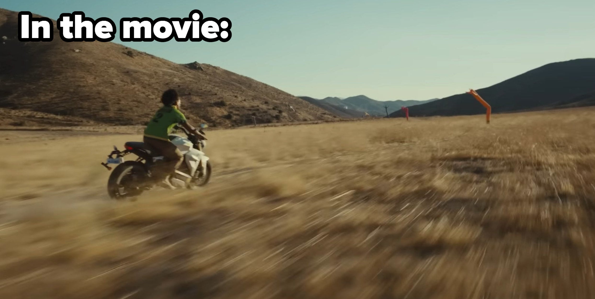 A character riding through fields on a motorcycle