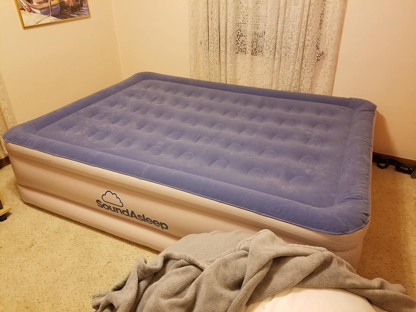 Reviewer's photo of the firm air mattress on the floor