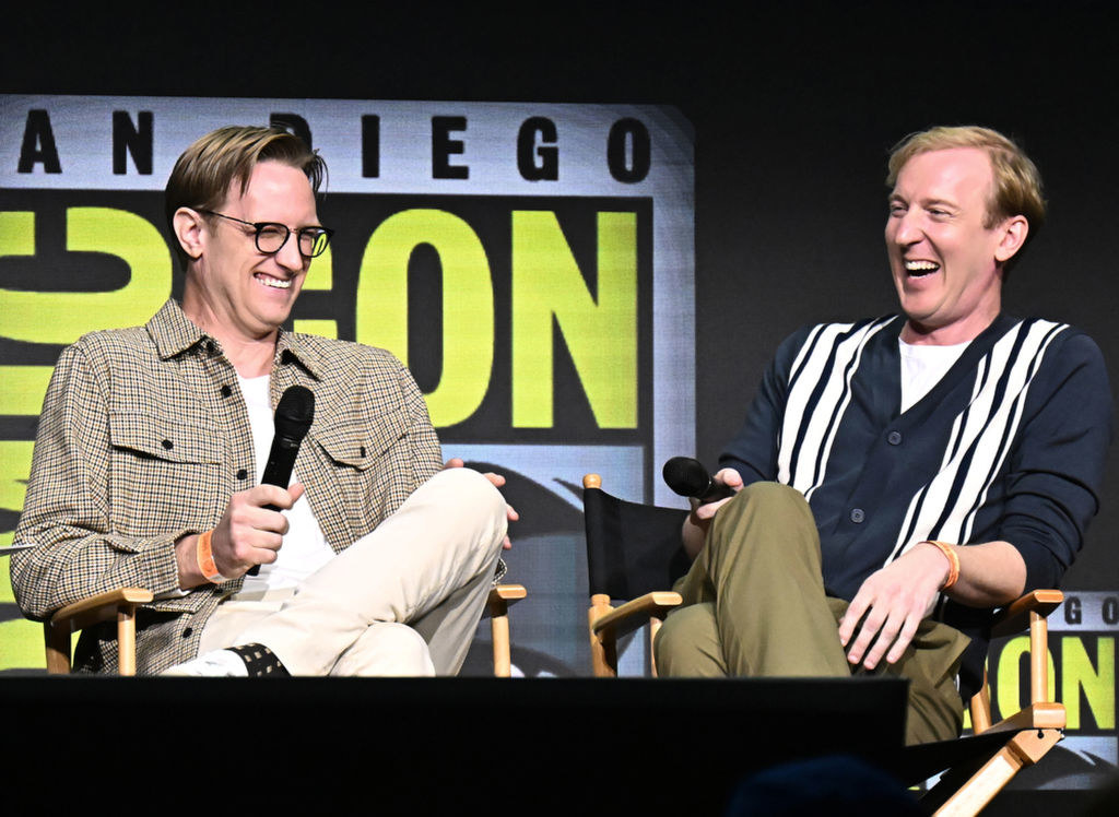 JD Payne and Patrick McKay speak onstage at The Lord of the Rings: The Rings of Power panel in Hall H at the 2022 Comic-Con International