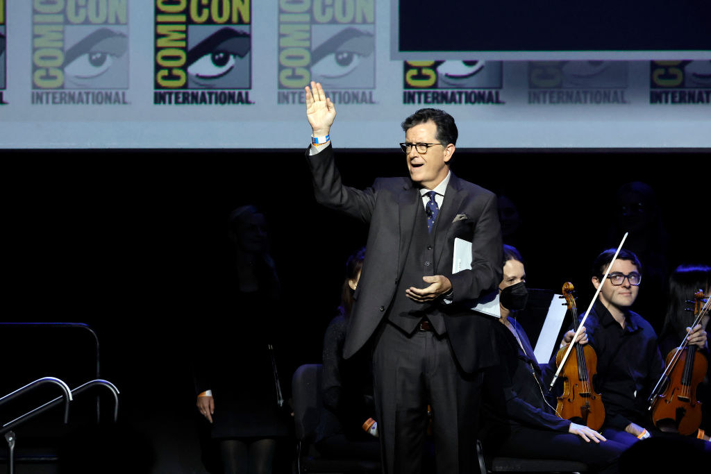 Stephen Colbert waves to the crowd from the Hall H stage