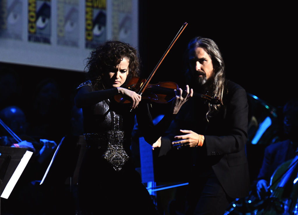 Bear McCreary and violinist perform onstage The Lord of the Rings: The Rings of Power panel in Hall H at the 2022 Comic-Con International