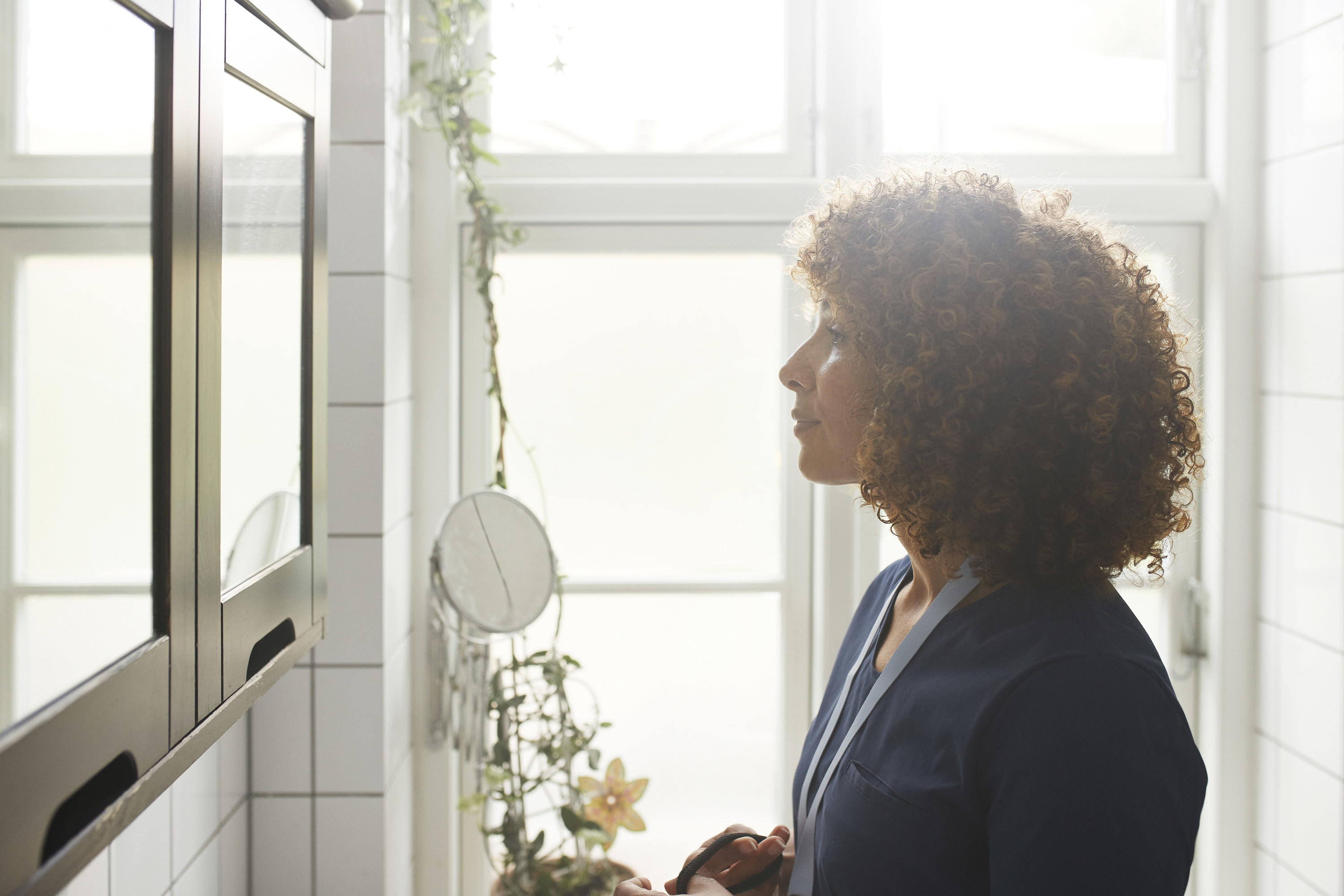 A woman looking at the mirror