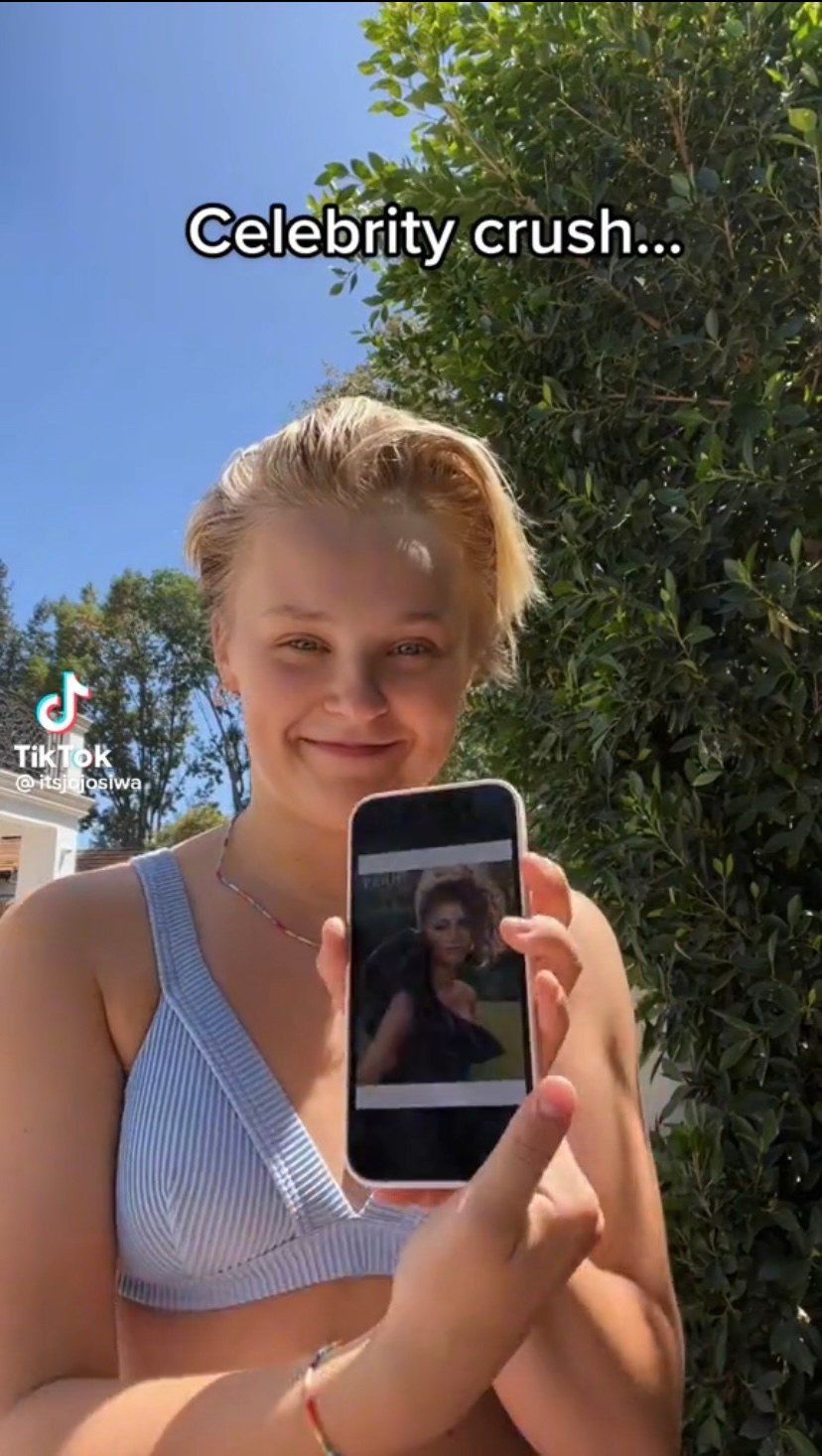 JoJo holds up her phone with a photo of Zendaya