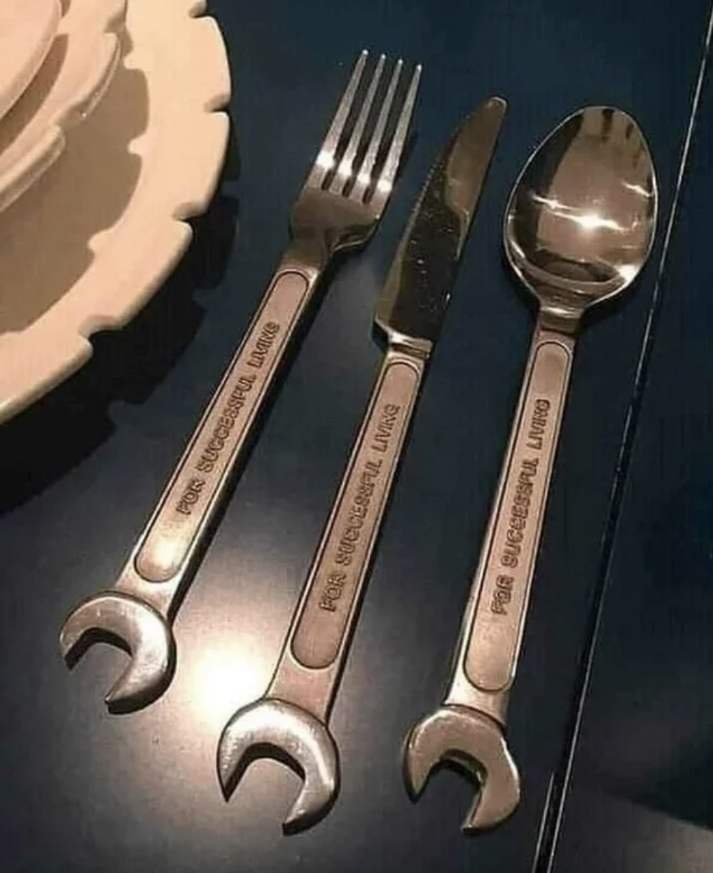 fork, spoon, and knife on one side and wrench on the other