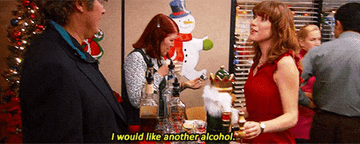 A woman asking for a drink at an office party