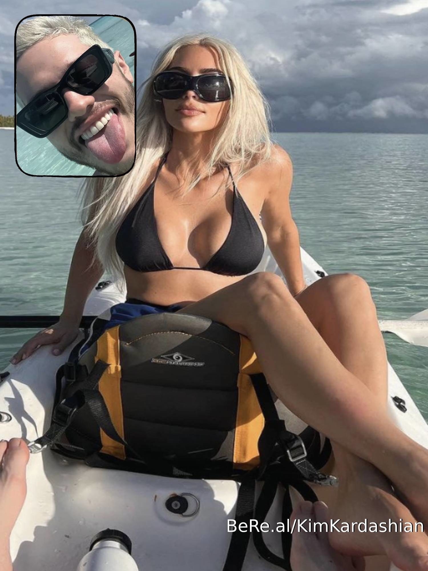 Pete Davidson smiling with his tongue out while Kim Kardashian poses on a boat