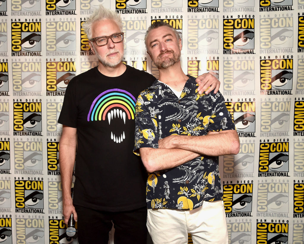 Sean smiling while James puts his arm around him in front of a Comic-Con backdrop