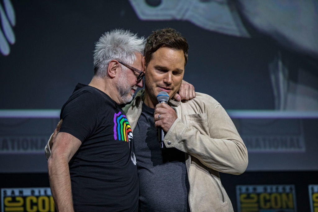 James hugging Chris Pratt on stage as Chris talks into a microphone