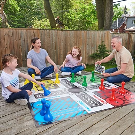 a family playing with the giant game on their deck